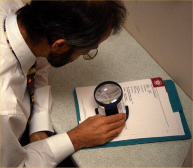 reading with a stand magnifier glass